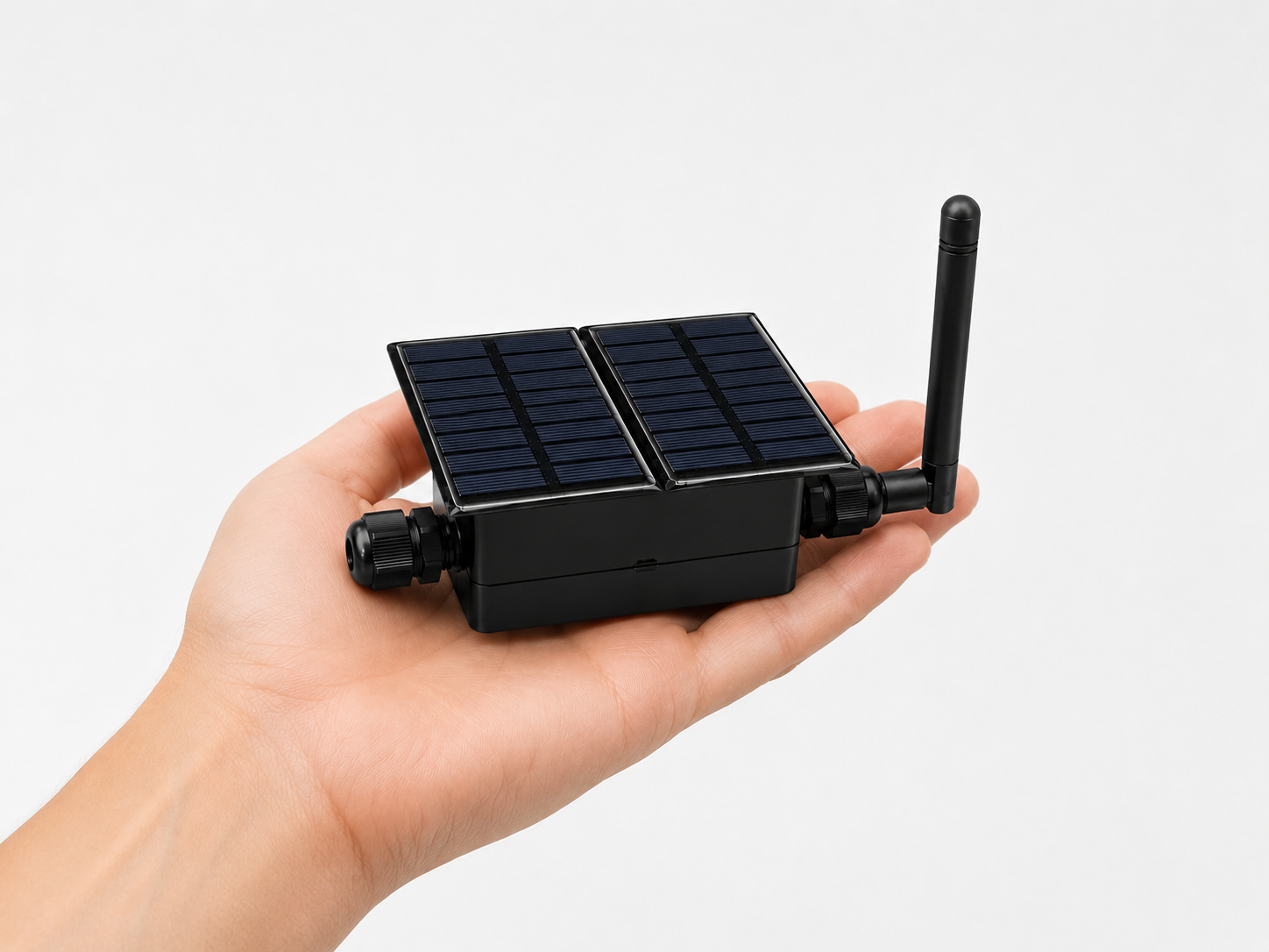 Strix field terminal held against a mountain landscape with mesh sensor network glowing at night